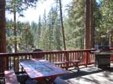 This Yosemite rental cabin has a convenient picnic table and plenty of seating for relaxing and family dinners outside