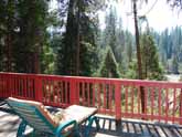 This Yosemite Forest cabin for rent has comfortable seating on the deck and great views of the Merced River
